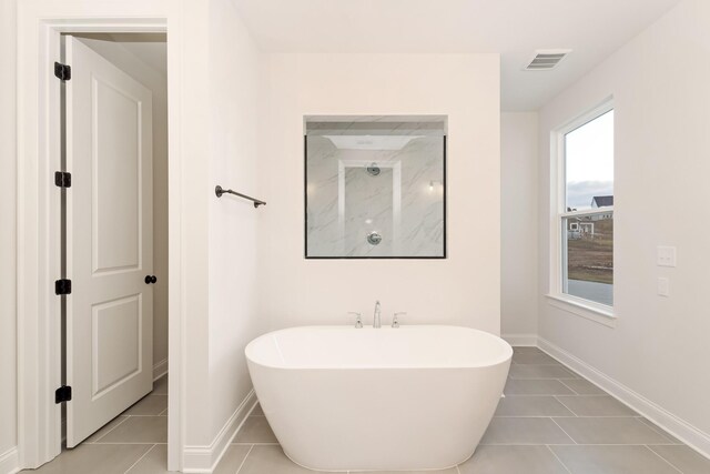 7406 Black Fox Dr, Fairview, TN 37062 - full bathroom with a soaking tub, tile patterned floors, and baseboards