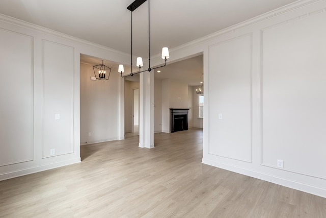 7406 Black Fox Dr, Fairview, TN 37062 - unfurnished dining area featuring a chandelier, light wood-style floors, crown molding, and baseboards