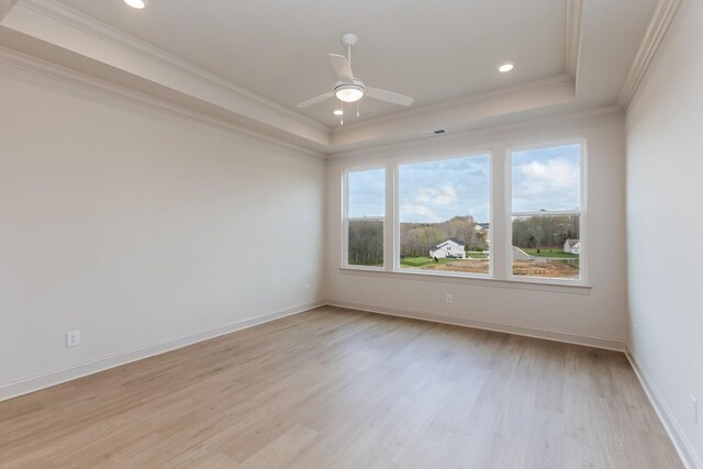 7406 Black Fox Dr, Fairview, TN 37062 - spare room featuring a tray ceiling, ornamental molding, light wood finished floors, a ceiling fan, and baseboards