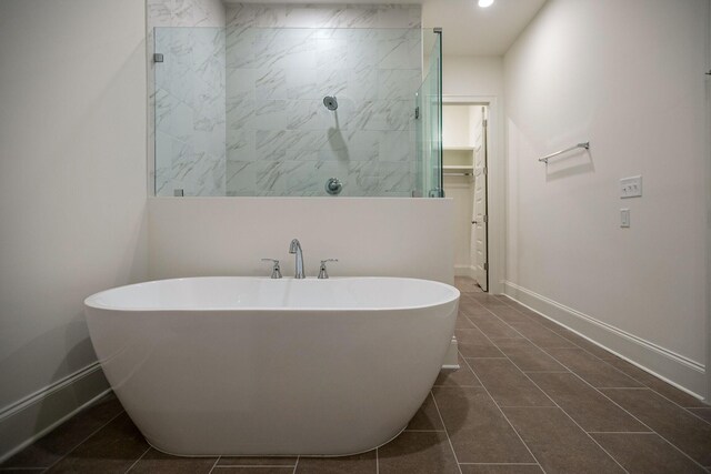 7413 Black Fox Dr, Fairview, TN 37062 - full bathroom with a freestanding tub, baseboards, a tile shower, tile patterned flooring, and a spacious closet
