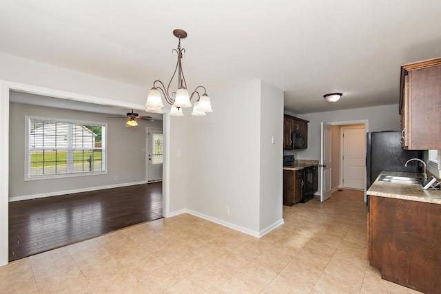 552 Magnolia Dr, Clarksville, TN 37042 - kitchen with black appliances, a sink, dark brown cabinetry, a ceiling fan, and baseboards