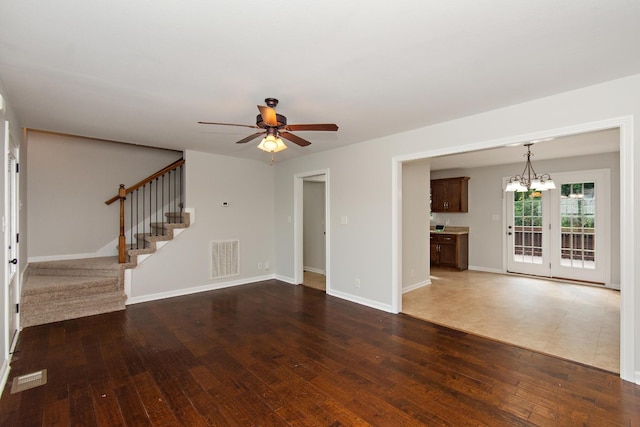 552 Magnolia Dr, Clarksville, TN 37042 - unfurnished living room featuring hardwood / wood-style floors, ceiling fan, stairway, a chandelier, and baseboards
