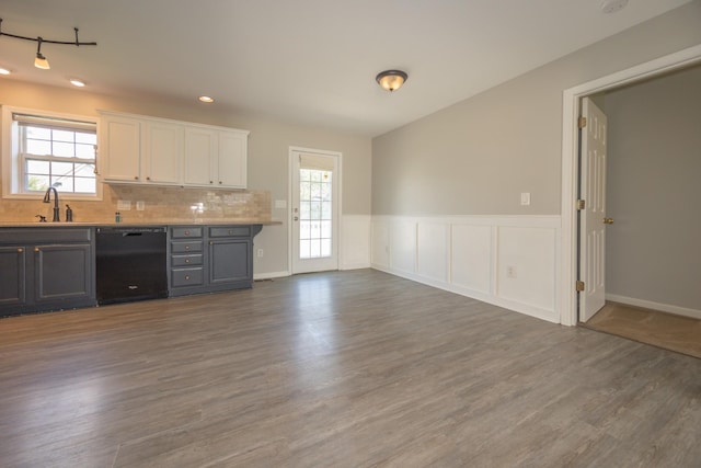1905 Bugle Ct, Spring Hill, TN 37174 - kitchen featuring dishwasher, wood finished floors, backsplash, white cabinets, and wainscoting