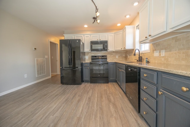1905 Bugle Ct, Spring Hill, TN 37174 - kitchen with black appliances, white cabinets, backsplash, light wood-type flooring, and recessed lighting