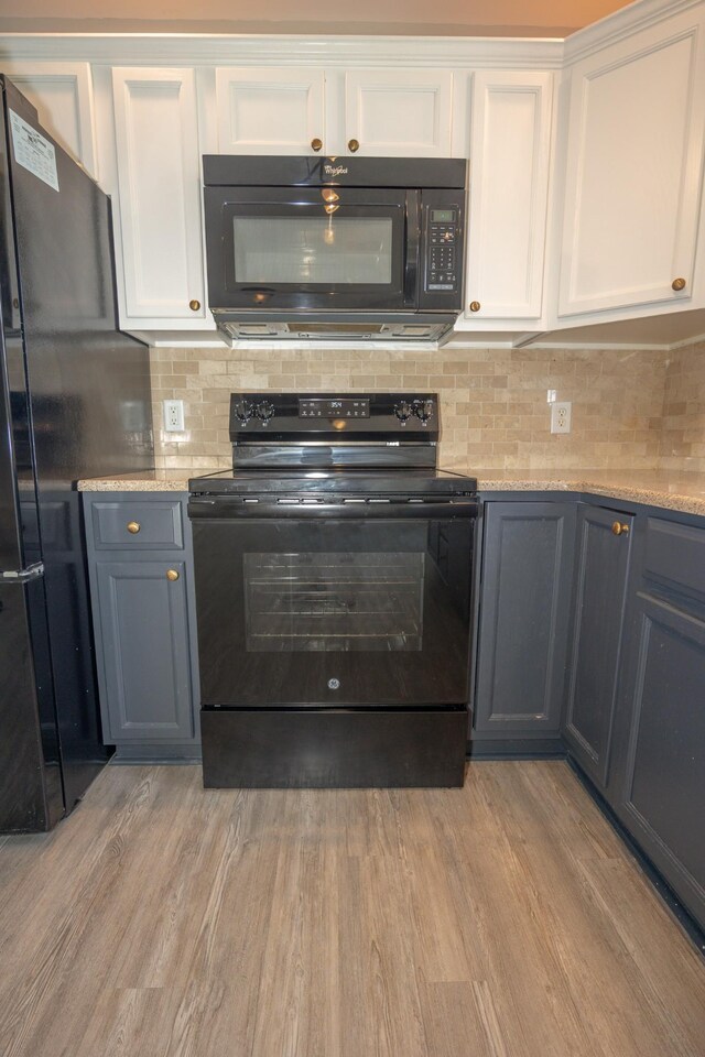 1905 Bugle Ct, Spring Hill, TN 37174 - kitchen featuring black appliances, white cabinets, tasteful backsplash, light wood-style flooring, and light stone countertops