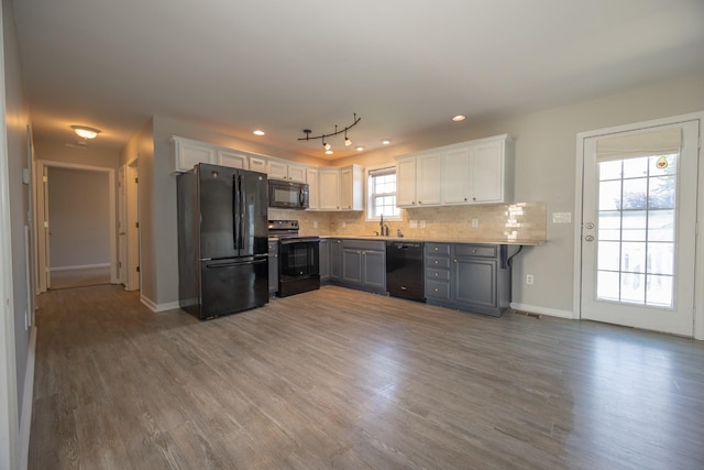 1905 Bugle Ct, Spring Hill, TN 37174 - kitchen with black appliances, wood finished floors, white cabinets, decorative backsplash, and recessed lighting
