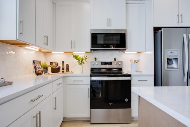 5220 Gladecress Ln NE, Hermitage, TN 37076 - kitchen with stainless steel appliances, backsplash, and white cabinetry