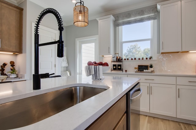5220 Gladecress Ln NE, Hermitage, TN 37076 - kitchen featuring light countertops, a sink, ornamental molding, backsplash, and hanging light fixtures