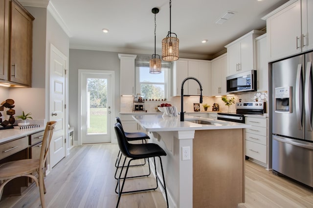5220 Gladecress Ln NE, Hermitage, TN 37076 - kitchen featuring appliances with stainless steel finishes, a sink, light wood-style floors, decorative backsplash, and crown molding