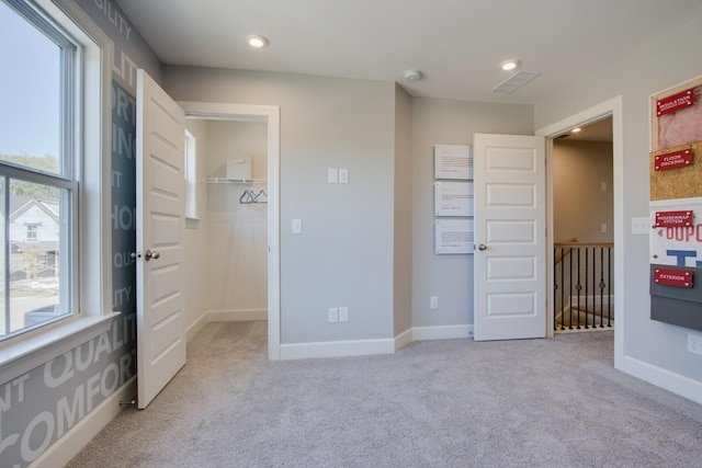 5220 Gladecress Ln NE, Hermitage, TN 37076 - unfurnished bedroom with light carpet, a walk in closet, baseboards, and recessed lighting
