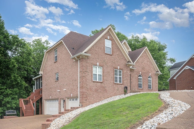 1245 Ben Hill Blvd, Nolensville, TN 37135 - view of property exterior with brick siding, an attached garage, driveway, and stairway