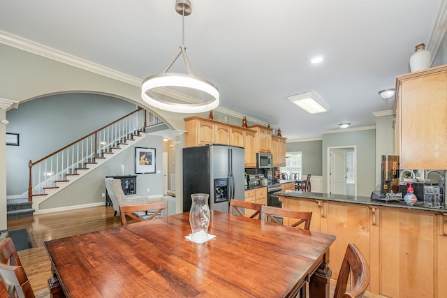 1245 Ben Hill Blvd, Nolensville, TN 37135 - dining space with crown molding, stairs, wood finished floors, arched walkways, and recessed lighting