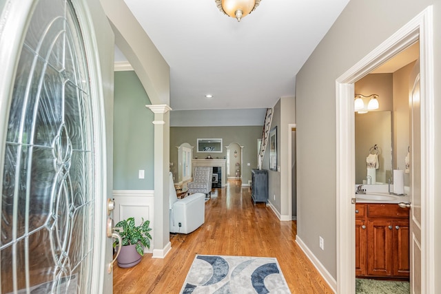 1245 Ben Hill Blvd, Nolensville, TN 37135 - foyer entrance with arched walkways, light wood-style floors, ornate columns, and wainscoting