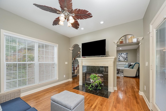 1245 Ben Hill Blvd, Nolensville, TN 37135 - living room featuring wood finished floors, a ceiling fan, arched walkways, baseboards, and recessed lighting