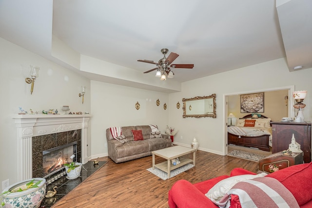 1245 Ben Hill Blvd, Nolensville, TN 37135 - living area with wood finished floors, a premium fireplace, a ceiling fan, and baseboards