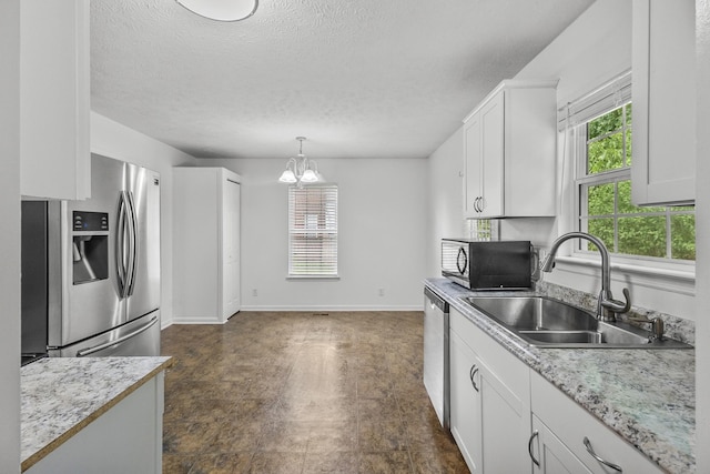 929 Chaparral Dr, Lebanon, TN 37087 - kitchen with stainless steel appliances, a sink, a chandelier, plenty of natural light, and a textured ceiling