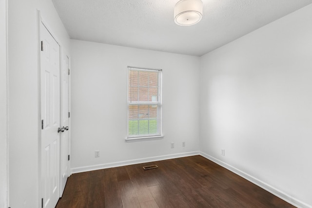 929 Chaparral Dr, Lebanon, TN 37087 - unfurnished bedroom with dark wood finished floors, baseboards, a closet, and a textured ceiling