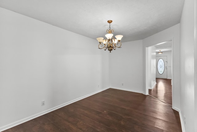 929 Chaparral Dr, Lebanon, TN 37087 - spare room featuring a chandelier, dark wood finished floors, baseboards, and a textured ceiling