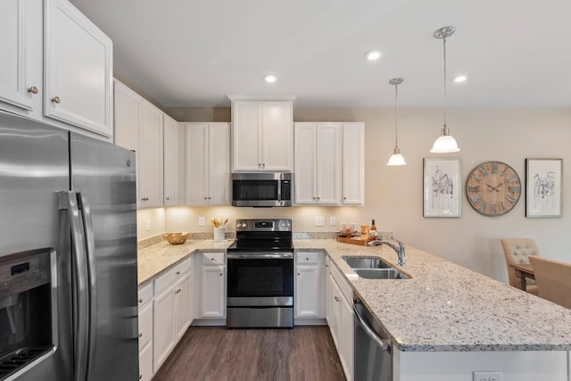 105 Primrose Ln, Gallatin, TN 37066 - kitchen with appliances with stainless steel finishes, a sink, a peninsula, dark wood-type flooring, and white cabinetry