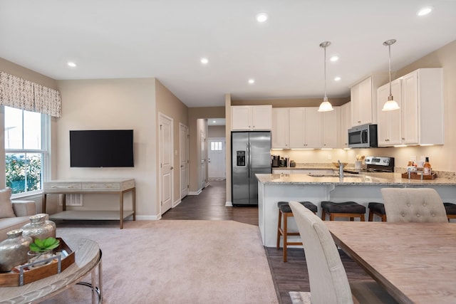 105 Primrose Ln, Gallatin, TN 37066 - kitchen featuring appliances with stainless steel finishes, light stone counters, a peninsula, white cabinets, and recessed lighting