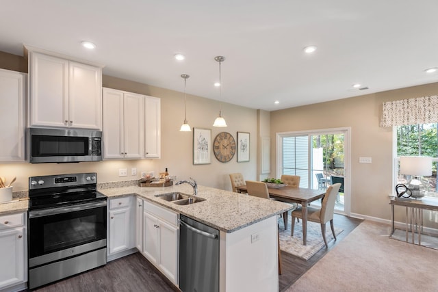 105 Primrose Ln, Gallatin, TN 37066 - kitchen with stainless steel appliances, a sink, a peninsula, white cabinetry, and dark wood-type flooring