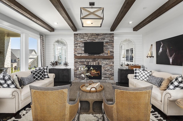 7890 Lampley Rd, Primm Springs, TN 38476 - living area featuring a stone fireplace and beamed ceiling