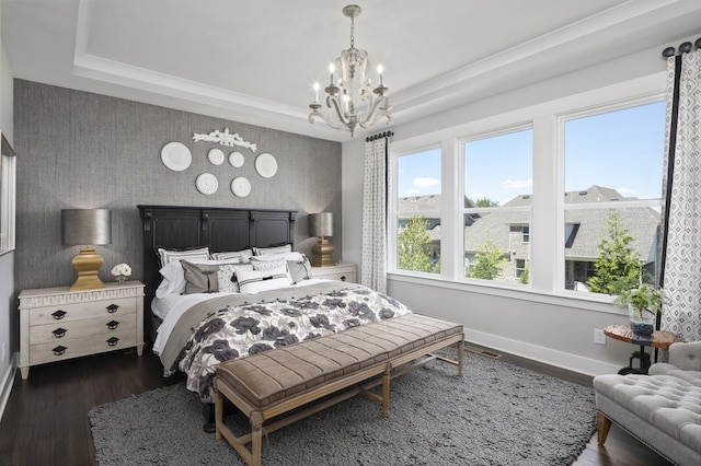 7890 Lampley Rd, Primm Springs, TN 38476 - bedroom with a chandelier, an accent wall, baseboards, and dark wood-style floors