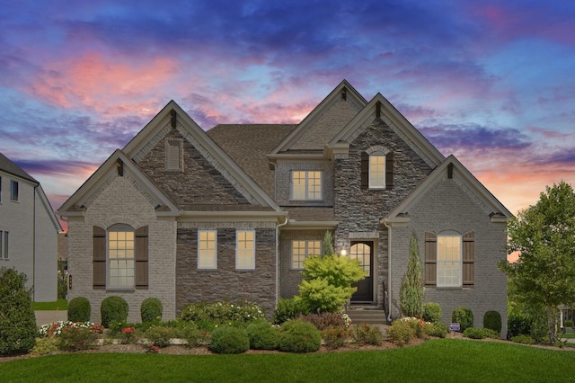 7890 Lampley Rd, Primm Springs, TN 38476 - view of front facade featuring a lawn and stone siding