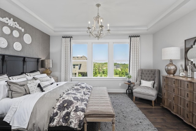 7890 Lampley Rd, Primm Springs, TN 38476 - bedroom featuring a chandelier, dark wood-style floors, a raised ceiling, an accent wall, and baseboards