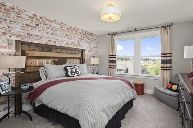 7890 Lampley Rd, Primm Springs, TN 38476 - carpeted bedroom with baseboards and brick wall