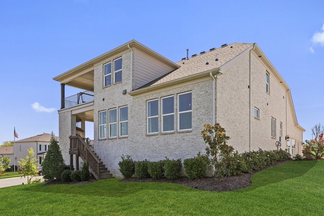 7890 Lampley Rd, Primm Springs, TN 38476 - view of property exterior featuring a balcony, a lawn, stairs, and brick siding
