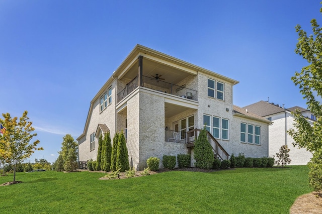 7890 Lampley Rd, Primm Springs, TN 38476 - rear view of house with a balcony, a ceiling fan, a yard, and brick siding