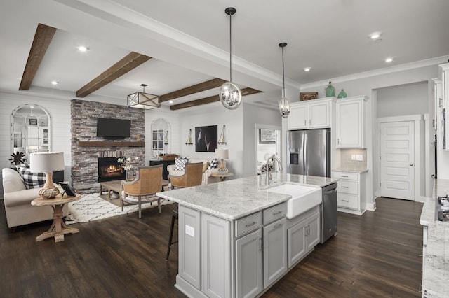 7890 Lampley Rd, Primm Springs, TN 38476 - kitchen with appliances with stainless steel finishes, a sink, open floor plan, a fireplace, and dark wood-style flooring