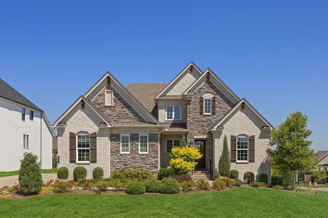 7890 Lampley Rd, Primm Springs, TN 38476 - craftsman-style home with a front lawn and stone siding