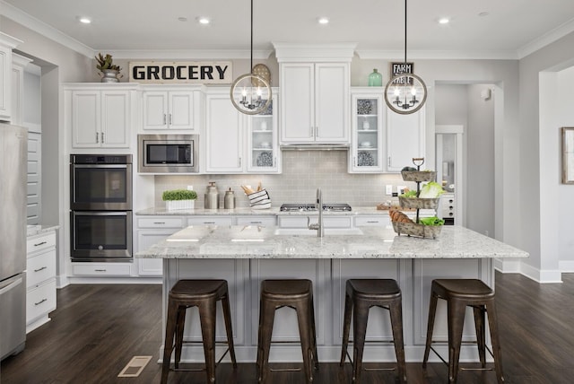 7890 Lampley Rd, Primm Springs, TN 38476 - kitchen featuring appliances with stainless steel finishes, a chandelier, dark wood-style floors, crown molding, and recessed lighting