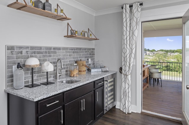 7890 Lampley Rd, Primm Springs, TN 38476 - indoor wet bar featuring decorative backsplash, wine cooler, dark wood-style flooring, crown molding, and baseboards