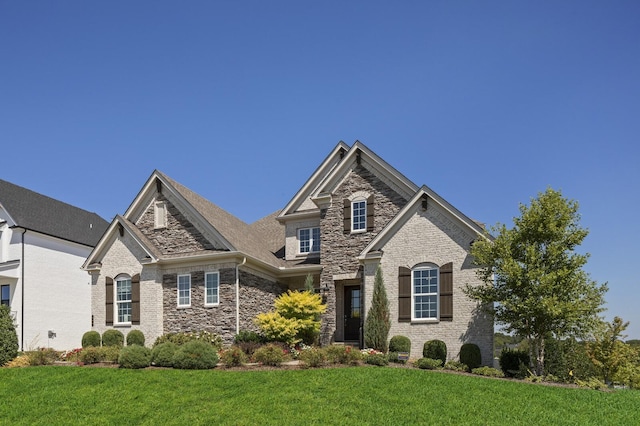 7890 Lampley Rd, Primm Springs, TN 38476 - view of front facade with stone siding and a front lawn