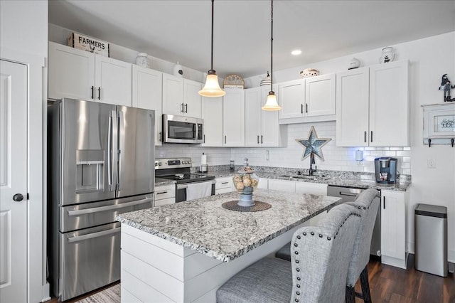 2183 Nectar Ln, Columbia, TN 38401 - kitchen with appliances with stainless steel finishes, a sink, a center island, backsplash, and light stone countertops
