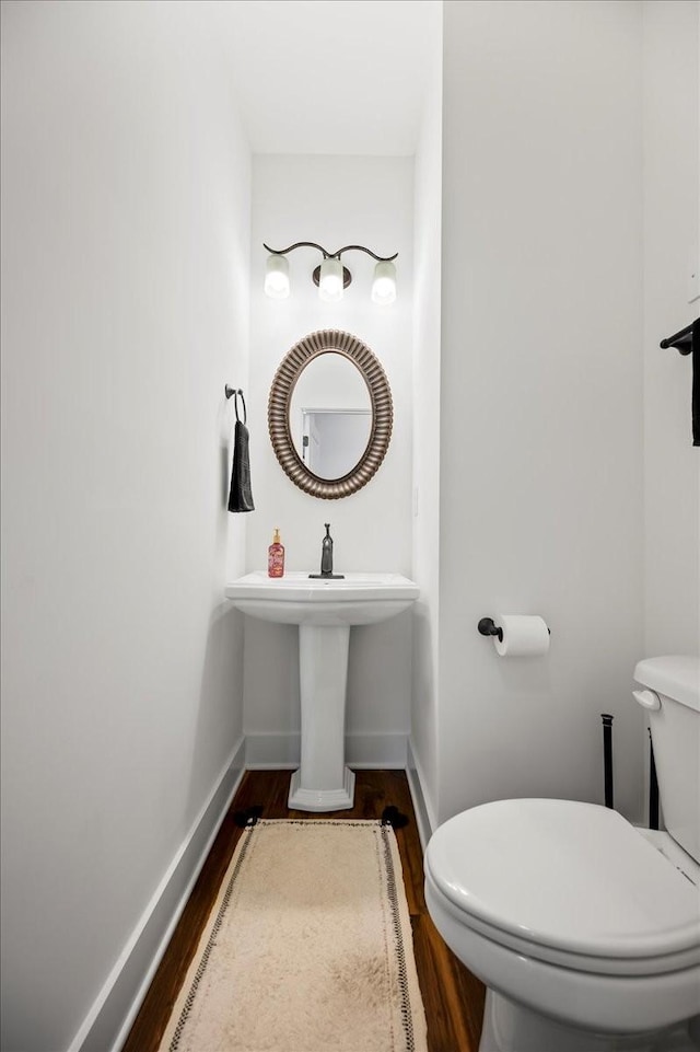 2183 Nectar Ln, Columbia, TN 38401 - bathroom featuring wood finished floors, toilet, and baseboards