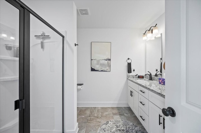 2183 Nectar Ln, Columbia, TN 38401 - bathroom with double vanity, a stall shower, baseboards, and stone finish floors