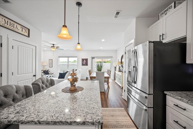 2183 Nectar Ln, Columbia, TN 38401 - kitchen with stainless steel fridge with ice dispenser, open floor plan, dark wood-style flooring, light stone counters, and white cabinets