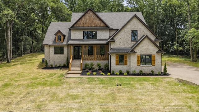 333 Burris Rd, Mount Juliet, TN 37122 - view of front of property with covered porch, a front yard, roof with shingles, and brick siding