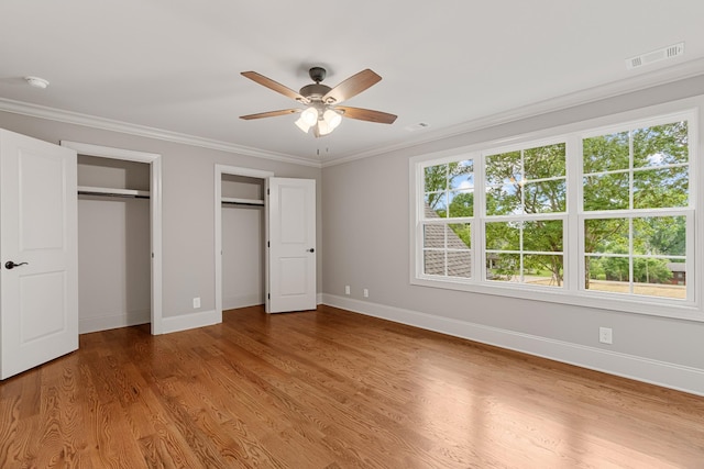 333 Burris Rd, Mount Juliet, TN 37122 - unfurnished bedroom featuring multiple closets, baseboards, wood finished floors, and ornamental molding