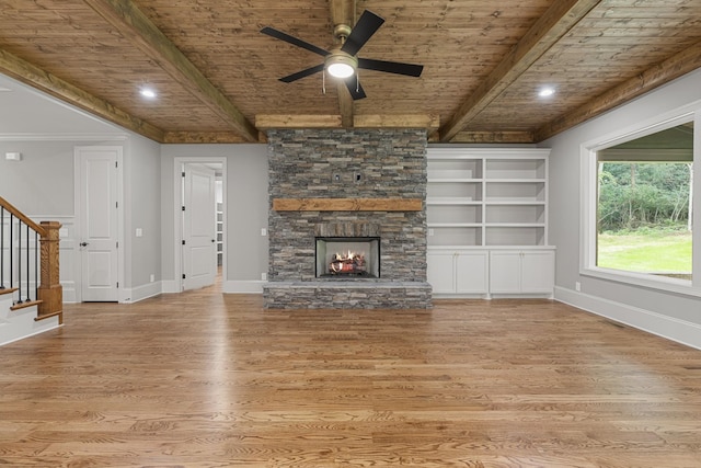 333 Burris Rd, Mount Juliet, TN 37122 - unfurnished living room featuring wooden ceiling with exposed beams, stairway, wood finished floors, a ceiling fan, and a stone fireplace