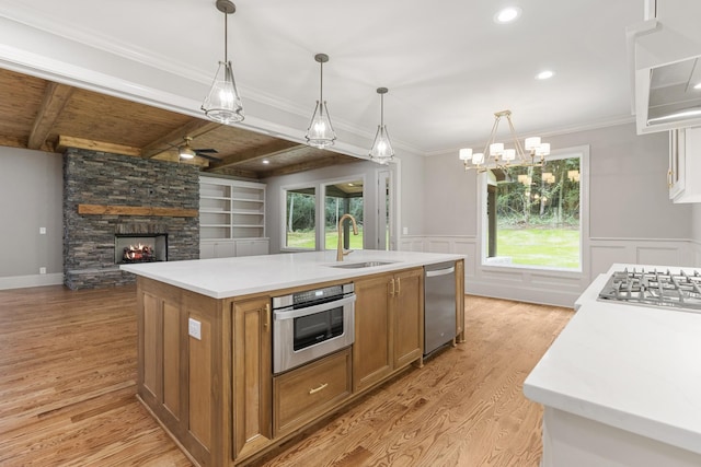 333 Burris Rd, Mount Juliet, TN 37122 - kitchen featuring a sink, appliances with stainless steel finishes, brown cabinets, light wood-type flooring, and open floor plan