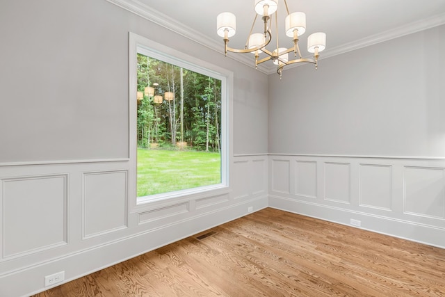 333 Burris Rd, Mount Juliet, TN 37122 - empty room featuring a chandelier, crown molding, light wood-type flooring, wainscoting, and a decorative wall
