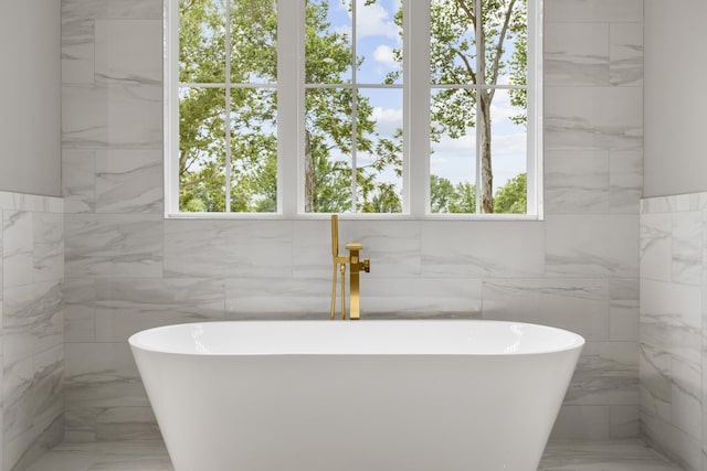 333 Burris Rd, Mount Juliet, TN 37122 - bathroom with marble tiled flooring, plenty of natural light, a soaking tub, and tile walls
