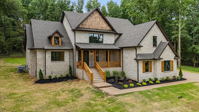 333 Burris Rd, Mount Juliet, TN 37122 - french country home with covered porch, a front yard, central air condition unit, and a shingled roof