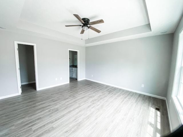 100 Wt Hardison Ave, Portland, TN 37148 - empty room featuring a tray ceiling, baseboards, and wood finished floors