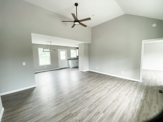 100 Wt Hardison Ave, Portland, TN 37148 - unfurnished living room featuring a ceiling fan, wood finished floors, high vaulted ceiling, and baseboards